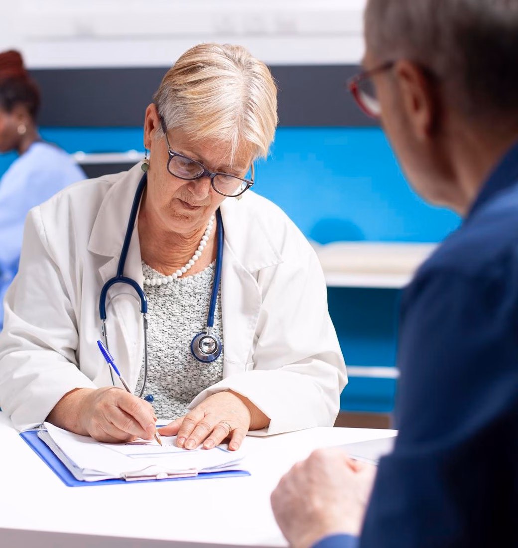 Doctor consulting with a patient and taking notes