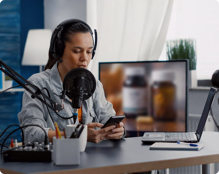 Creator filming a wellness segment with studio mic and laptop